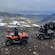 A group of all terrain vehicle riders exploring a rugged mountain pass